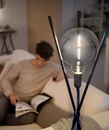 Man aan het lezen naast een door Philips Modern ontworpen LED-lamp 